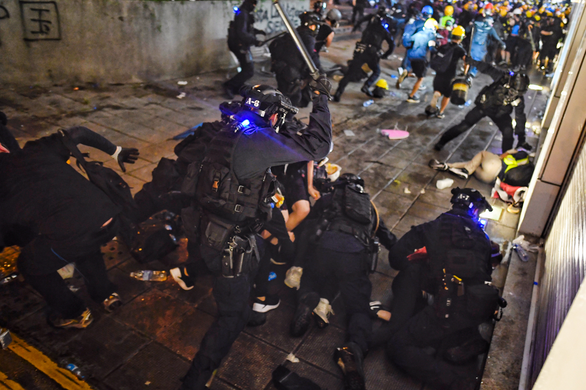 Police disperse pro-democracy protesters outside Tsim Sha Tsui Police station during a demonstration against the controversial extradition bill in Hong Kong on August 11, 2019. - Empty hotel rooms, st