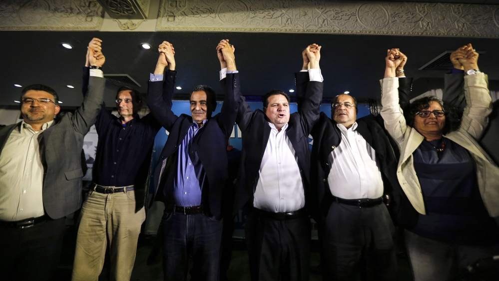 Ayman Odeh (3rd R), head of the Joint Arab List, reacts with members of the party after exit poll results in Nazareth March 17, 2015. Prime Minister Benjamin Netanyahu closed a gap with center-left ri