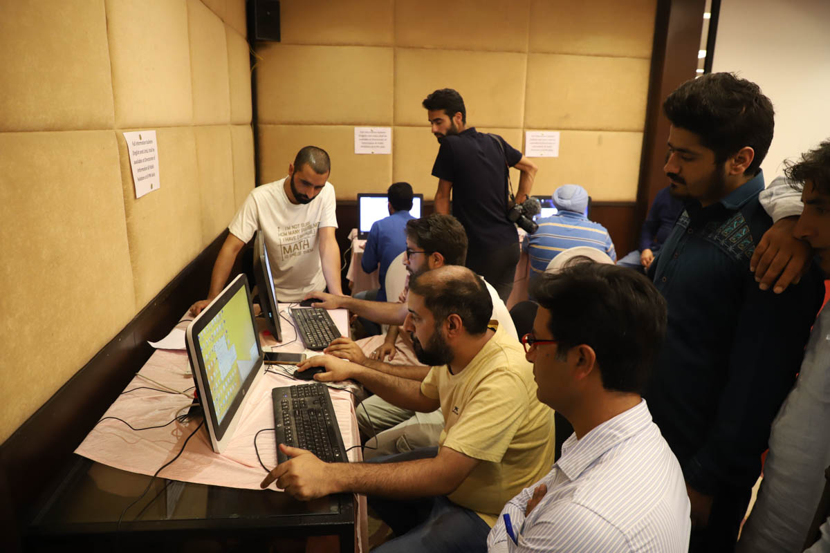 Journalists wait for their turns to access internet at the Media facilitation center made by the government, a facility of five computers with internet is being provided for number of journalists, a f