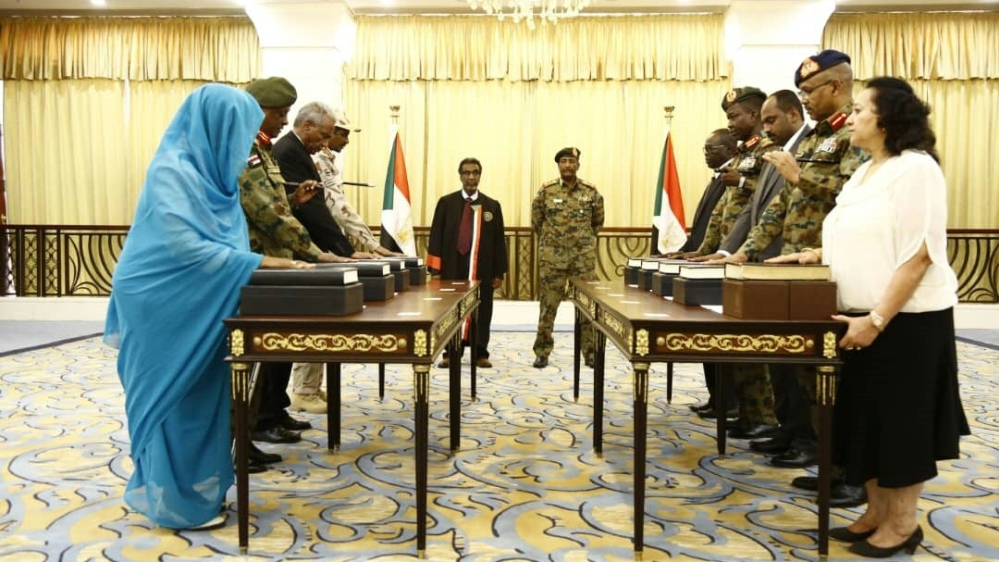 A picture released by Sudan''s Presidential Palace shows General Abdel Fattah al-Burhan (C-R), the head of Sudan''s ruling military council, standing during a swearing in of the new sovereign council, i
