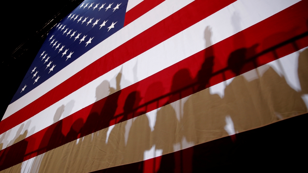 The shadows of supporters of U.S. President Donald Trump are seen on an American Flag at a campaign rally in Las Vegas