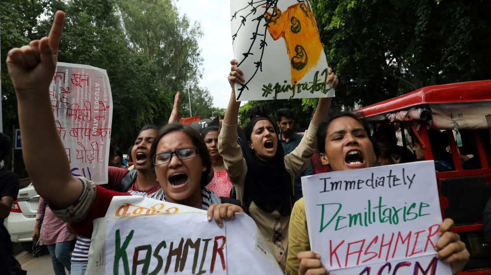 Students display placards and shout slogans during a protest against the scrapping of the special constitutional status for Kashmir by the government, in New Delhi