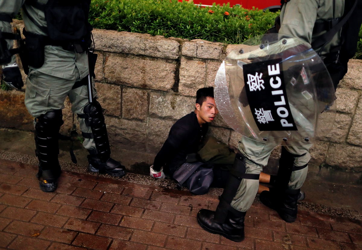 Riot police officers detain an anti-extradition bill protester during a demonstration in Tsim Sha Tsui neighbourhood in Hong Kong, China, August 11, 2019. REUTERS/Issei Kato