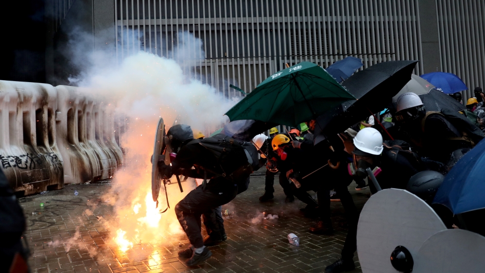 Demonstrators take cover during a protest in Hong Kong