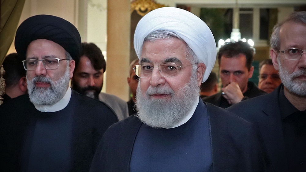 A handout picture provided by the Iranian presidency on September 4, 2019 shows President Hassan Rouhani (C) before giving a speech after meeting with the Iranian Judiciary chief Ebrahim Raisi (L) and