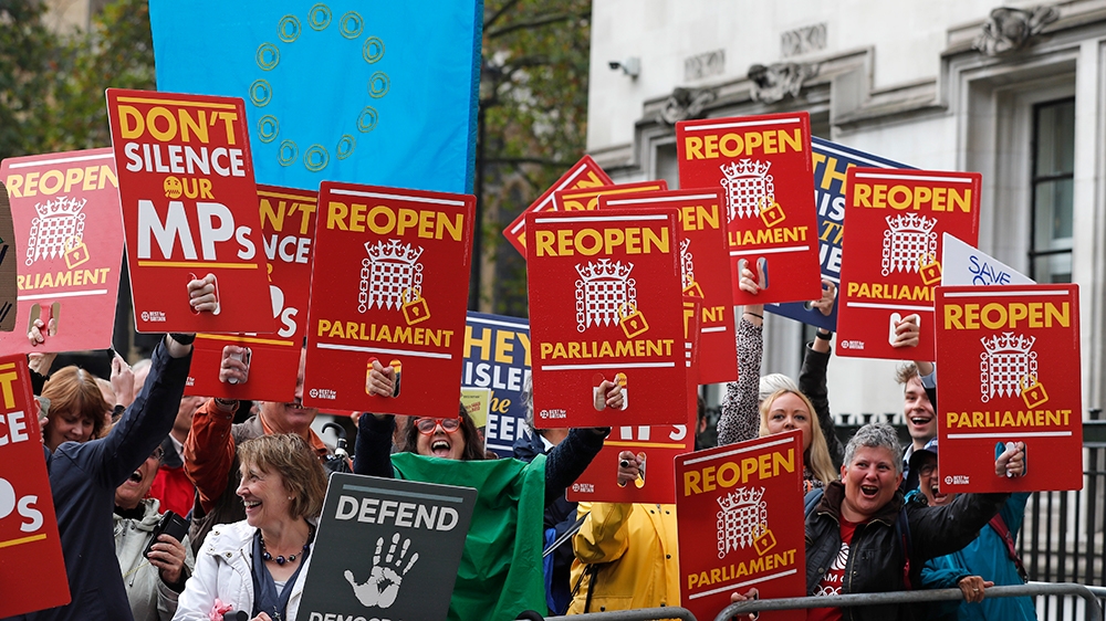 Anti-Brexit supporters react as they gather outside the Supreme Court in London, Tuesday, Sept. 24, 2019 as it makes it's decision on the legality of Prime Minister Boris Johnson's five-week suspensio