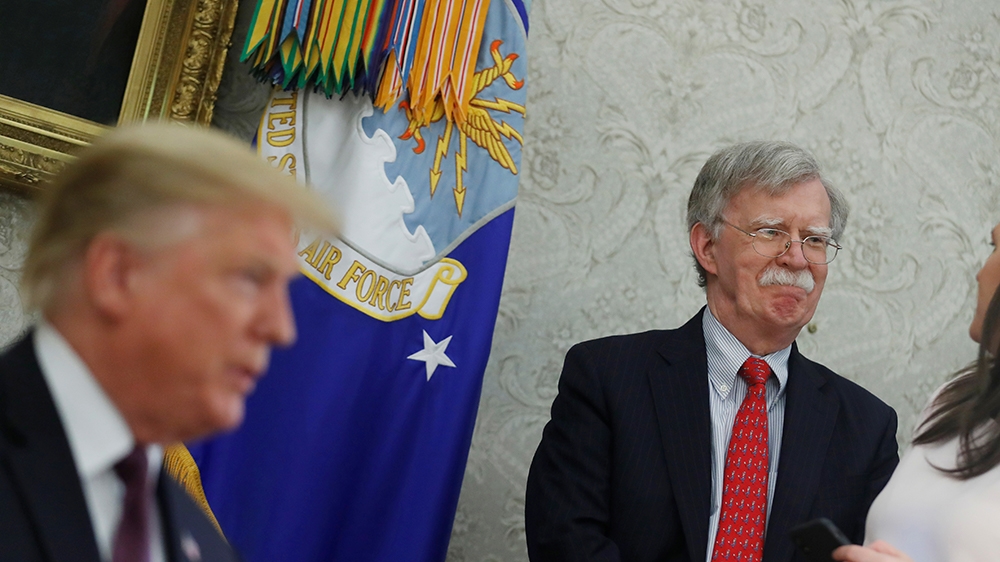 White House national security advisor John Bolton talks with Press Secretary Sarah Huckabee Sanders as U.S. President Donald Trump speaks during meeting with Hungary's Prime Minister Viktor Orban in t