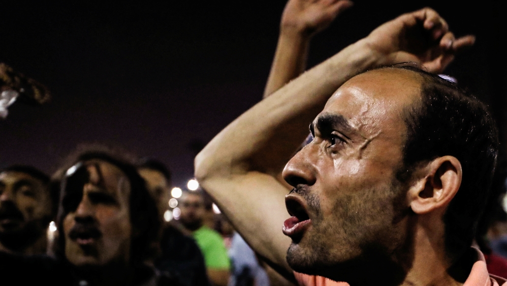 Small groups of protesters gather shouting anti-government slogans in central Cairo