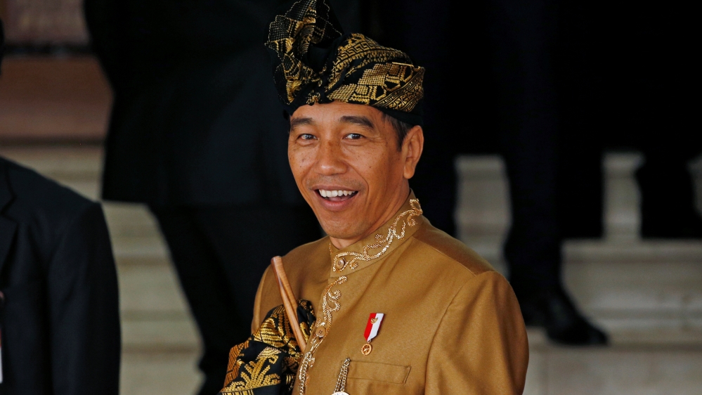 Indonesia''s President Joko Widodo reacts to reporters as he departs deliver address ahead of Independence Day at the parliament building in Jakarta