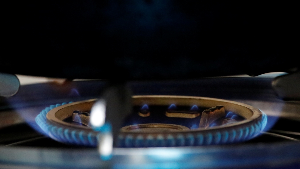 A gas flame burns on a newly installed stove in a kitchen in Xiaozhangwan village at the outskirts of Beijing
