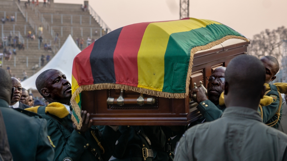 Soldiers carry the late President Mugabe''s casket into the helicopter back the family mansion where it will lie in state until another public viewing is held tomorrow. 