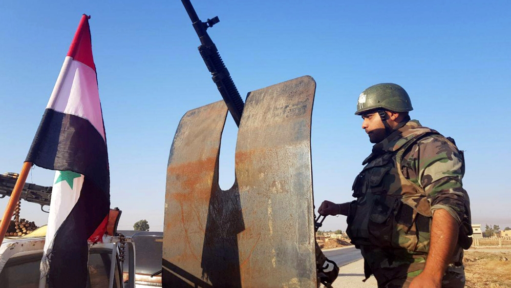 A Syrian army soldier is seen in the town of Tel Tamer in northeast Syria