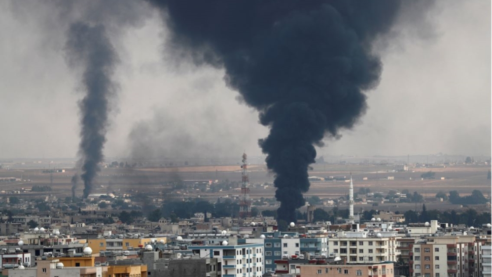 Smoke rises over the Syrian town of Ras al Ain, as seen from the Turkish border town of Ceylanpinar