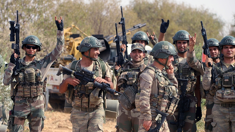 In this Monday, Oct. 14, 2019 photo, Turkish troops deploy in Syria''s northern region of Manbij. Syrian state media said Tuesday that government forces have entered the center of the once Kurdish-held