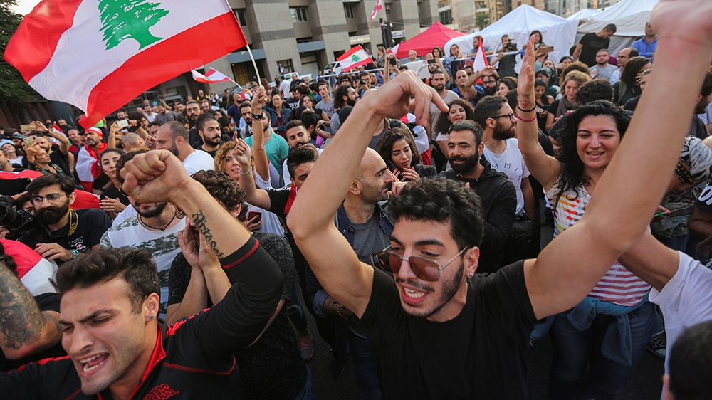 Protestors celebrate after Lebanon's Prime Minister Saad al-Hariri announced his resignation in Beirut, Lebanon October 29, 2019. REUTERS/Aziz Taher