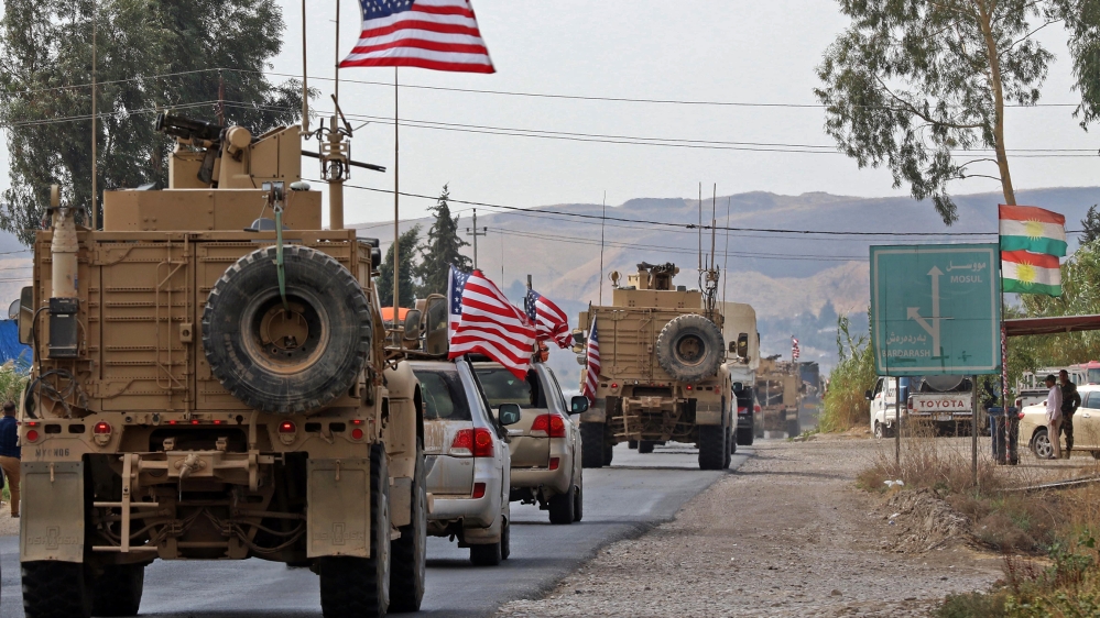 A convoy of US military vehicles arrives near the Iraqi Kurdish town of Bardarash in the Dohuk governorate after withdrawing from northern Syria on October 21, 2019. SAFIN HAMED / AFP
