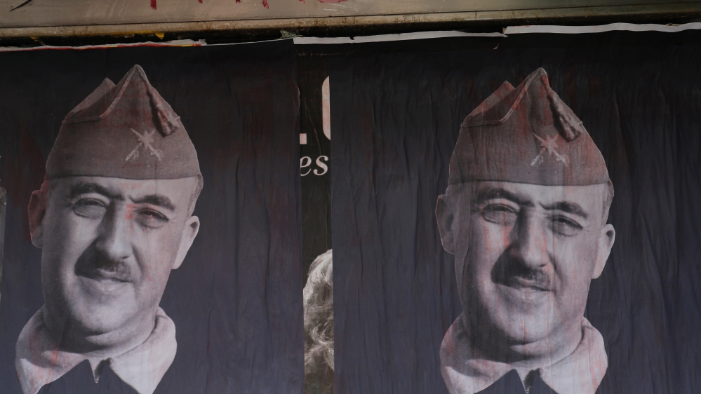 Banners of Spanish late dictator Francisco Franco are seen on a street the day before his exhumation in Madrid