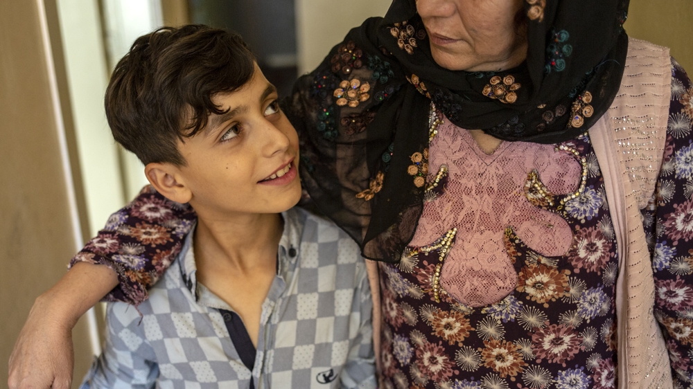 Umm Laund stands with her nephew in their Sanliurfa home