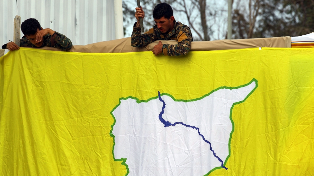 Fighters of Syrian Democratic Forces (SDF) put an SDF flag in al-Omar oil field in Deir Al Zor