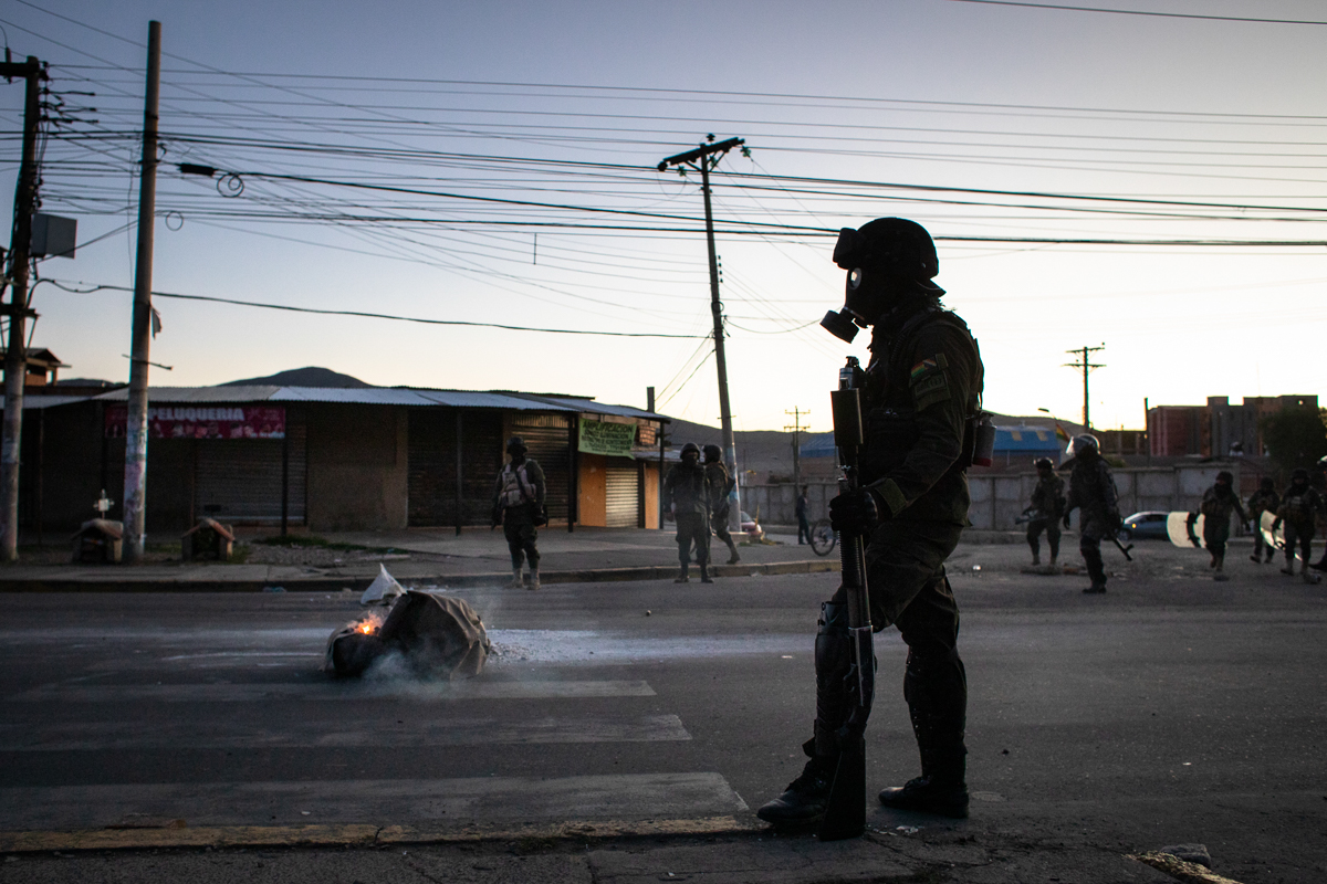Loaded with teargas and masks, antiriot police move towards demonstrators after violence erupted during a demonstration by supporters of Evo Morales. Over 3,000 protesters demanded access to Cochabama