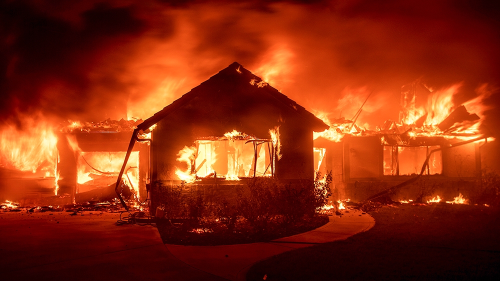 Flames from the Hillside Fire consume a home in San Bernardino, Calif., on Thursday, Oct. 31, 2019. The blaze, which ignited during red flag fire danger warnings, destroyed multiple residences. (AP Ph