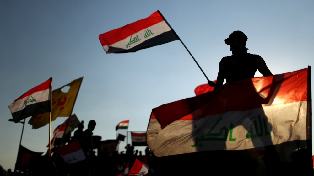 Iraqi demonstrators wave flags during the ongoing anti-government protests in Baghdad, Iraq November 1, 2019.