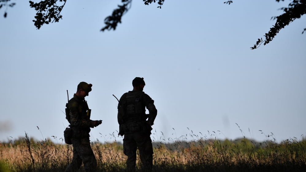 Soldiers await the arrival of Britain''s Prime Minister Boris Johnson on Salisbury plain training area near Salisbury