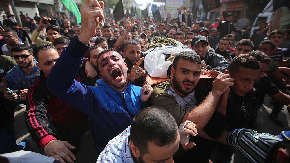 DEIR AL BALAH, GAZA - NOVEMBER 13: (EDITOR'S NOTE: Image depicts death) People carry the dead body of a 38-year-old Khalid Muavvad Ferrac, who was killed in Israeli airstrikes over Deir al Balah, duri