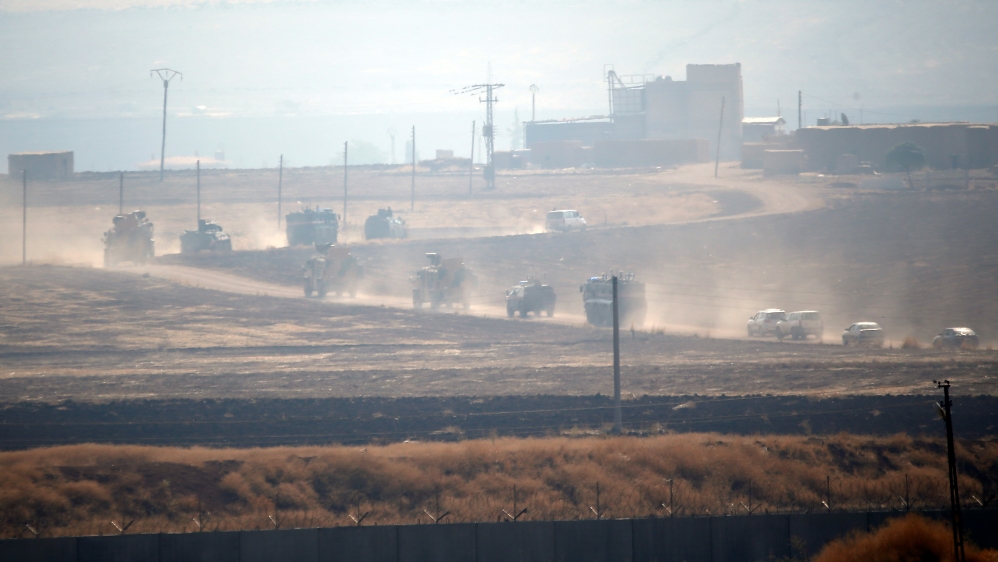 Turkish and Russian military vehicles are seen during a joint patrol in northeast Syria, as they are pictured near the Turkish border town of Kiziltepe