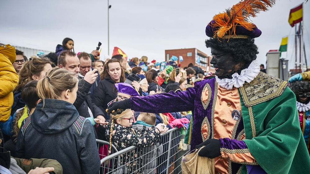 A sooty-faced Zwarte Pieten, or Black Pete, hands out treats during the arrival of Dutch Saint Nicholas, or Sinterklaas, in Scheveningen, Netherlands on November 16, 2019. The ''Black Petes'', people