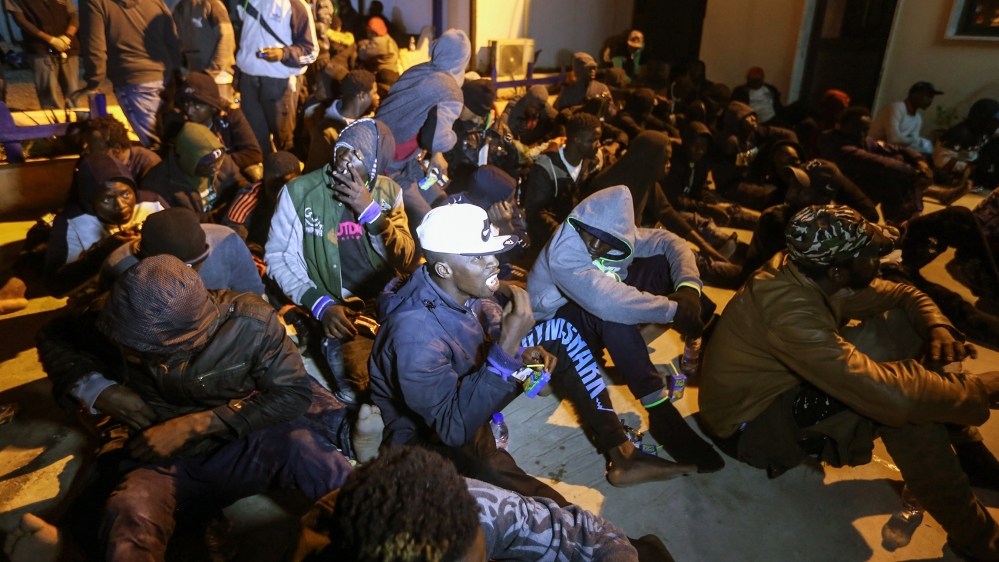 Migrants sait on the floor at a detention centre in Libya''s Tajoura, in the eastern suburbs of the capital Tripoli, late on November 29, 2019, after more than 200 migrants were rescued aboard three ru