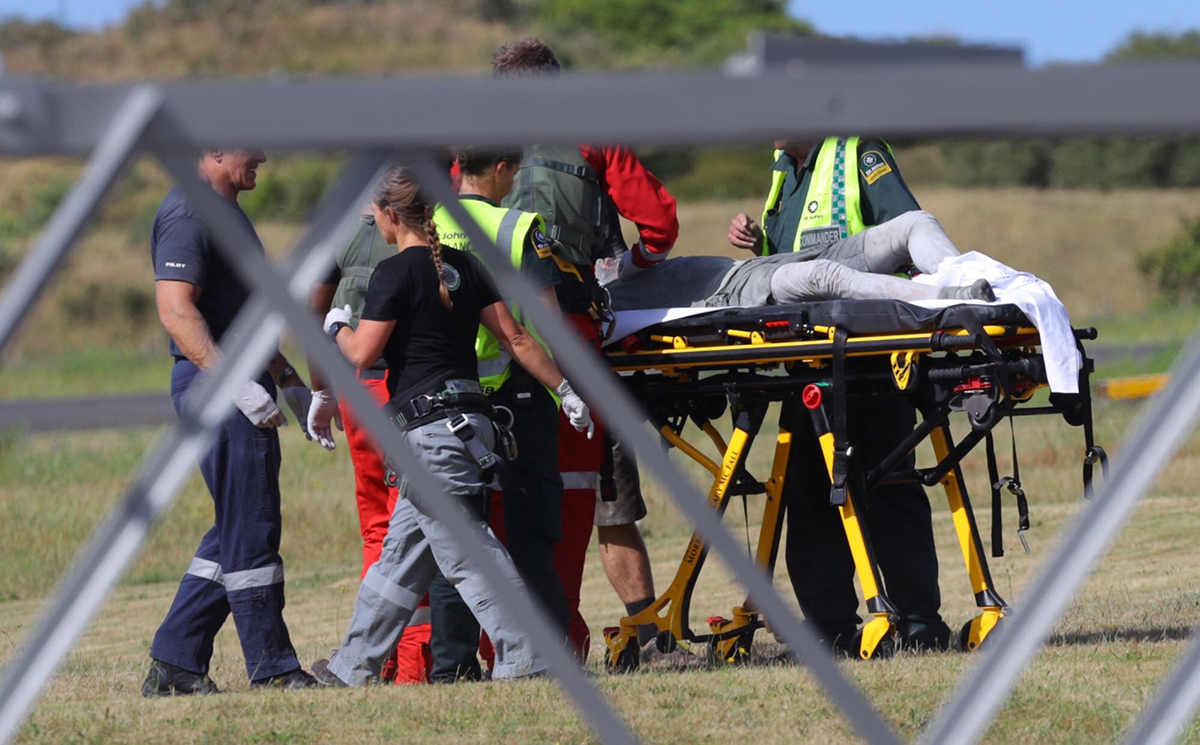Emergency services attend to an injured person arriving at the Whakatane Airfield after the volcanic eruption Monday, Dec. 9, 2019, on White Island, New Zealand. (Alan Gibson/New Zealand Herald via AP