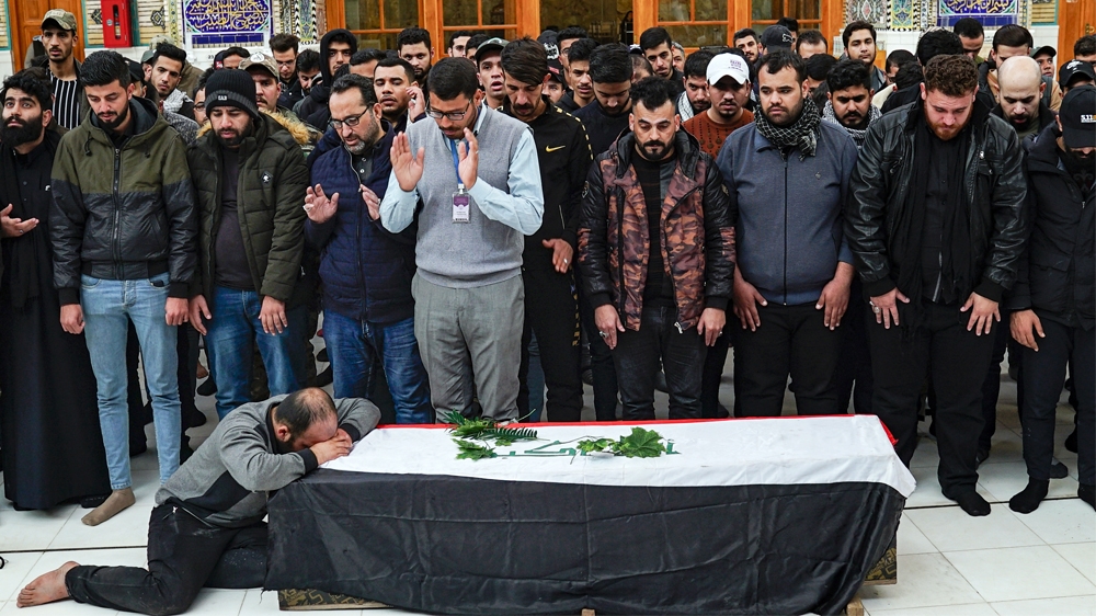 IRAQ-POLITICS-UNREST-FUNERAL A man weeps by the coffin of an Iraqi protester and citizen journalist, who was killed during a demonstrations the previous day in Baghdad,