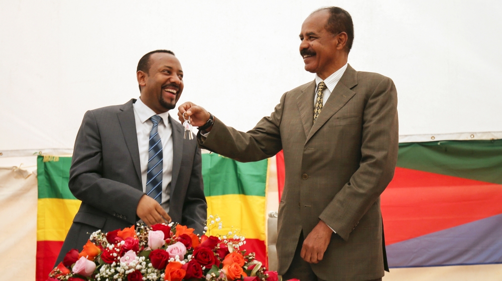 Eritrea's President Isaias Afwerki receives a key from Ethiopia's Prime Minister Abiy Ahmed during the inauguration ceremony marking the reopening of the Eritrean Embassy in Addis Ababa