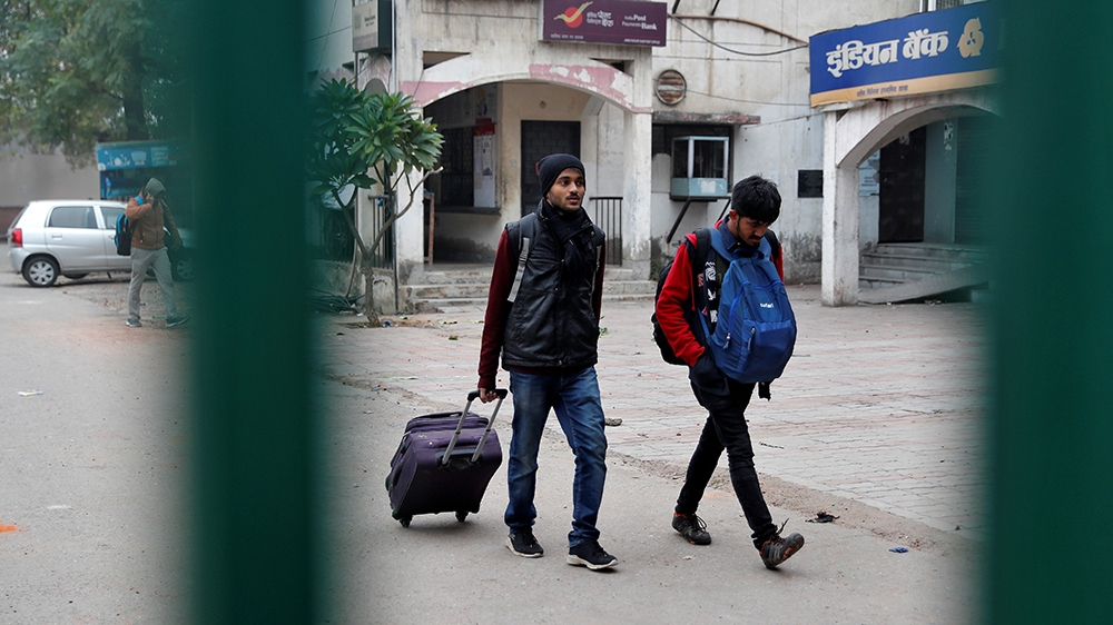 Students of the Jamia Millia Islamia university carrying their belongings leave the university campus in New Delhi, India, December 16, 2019. REUTERS/Adnan Abidi
