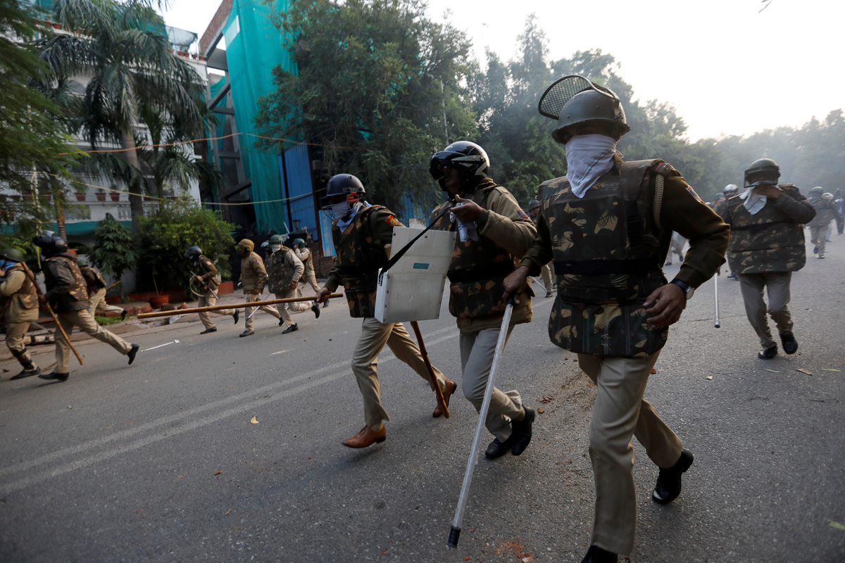 Police chase away demonstrators during a protest against a new citizenship law, in New Delhi, India, December 15, 2019. REUTERS/Adnan Abidi