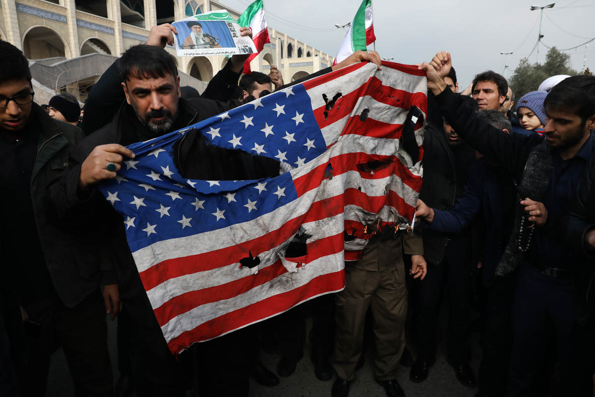 Protesters burn a U.S. flag during a demonstration over the U.S. airstrike in Iraq that killed Iranian Revolutionary Guard Gen. Qassem Soleimani, in Tehran, Iran, Jan. 3, 2020. Iran has vowed