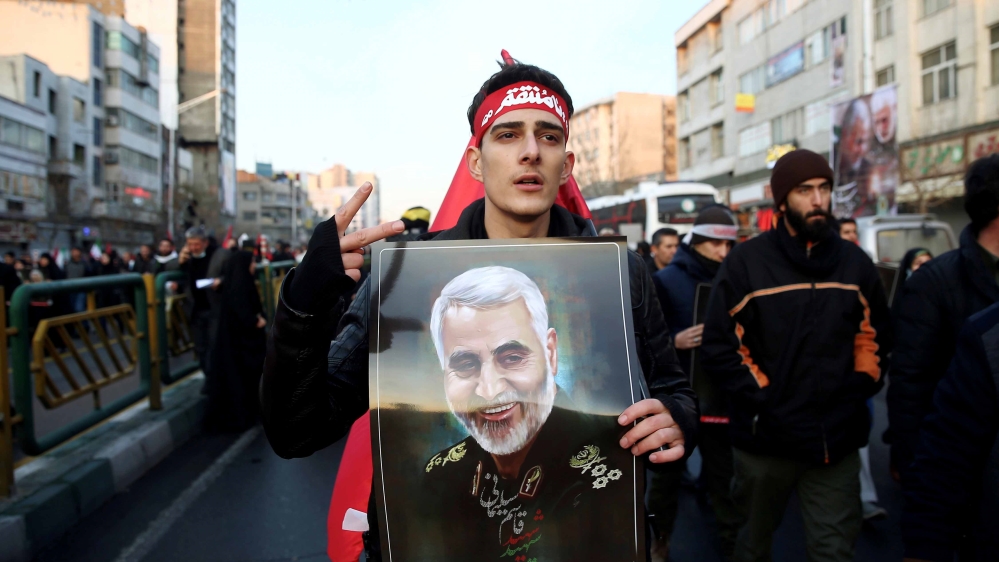 A man holds a picture of Iran’s Major-General Qassem Soleimani, head of the elite Quds Force, at his funeral procession in Tehran, Iran, on January 6, 2020