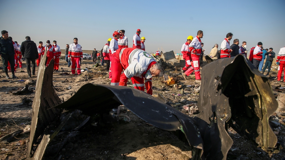 Red Crescent workers check the debris from the Ukraine International Airlines plane on the outskirts of Tehran, Iran January 8. Nazanin Tabatabaee/WANA