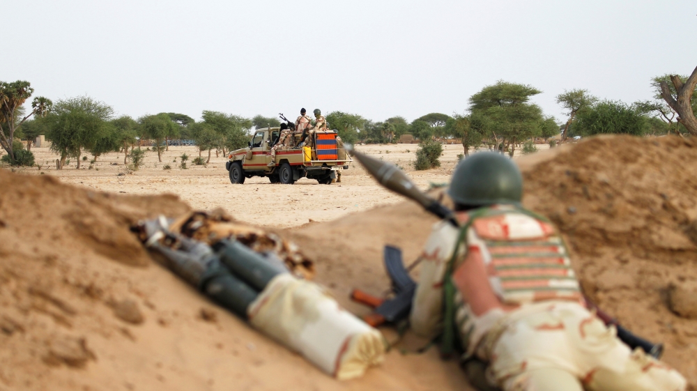 Niger soldiers guard with their weapons pointed towards the border with neighbouring Nigeria, near the town of Diffa