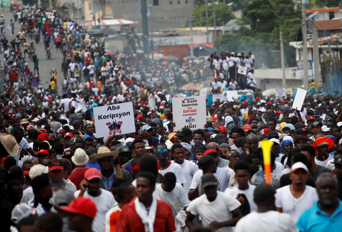 Protesters march during a demonstration to demand the resignation of Haitian President Jovenel Moise, in the streets of Port-au-Prince, Haiti October 20, 2019. REUTERS/Andres Martinez Casares