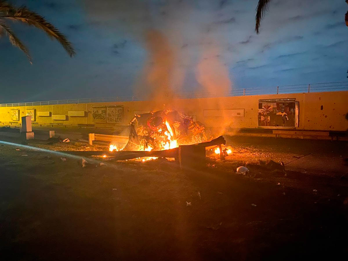 This photo released by the Iraqi Prime Minister Press Office shows a burning vehicle at the Baghdad International Airport following an airstrike in Baghdad, Iraq, early Friday, Jan. 3, 2020. The Penta