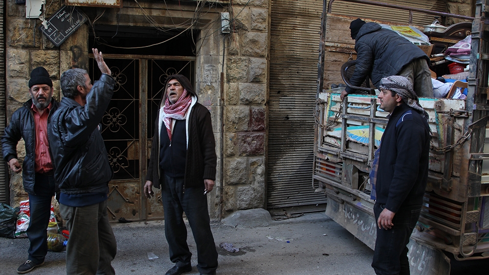 Syrians load their belongings into a truck before driving away from Maaret Al-Numan in the northwestern Idlib province on January 13, 2020. (Photo by Abdulaziz KETAZ / AFP)