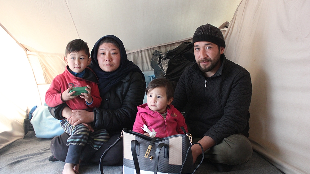 L-R Mohammed Ahmadi 2 years old, Fawzia Ahmadi, 26, Hassan Ahmadi, 30, Daughter 1 year old in Moria Refugee Camp [Katy Fallon/Al Jazeera]