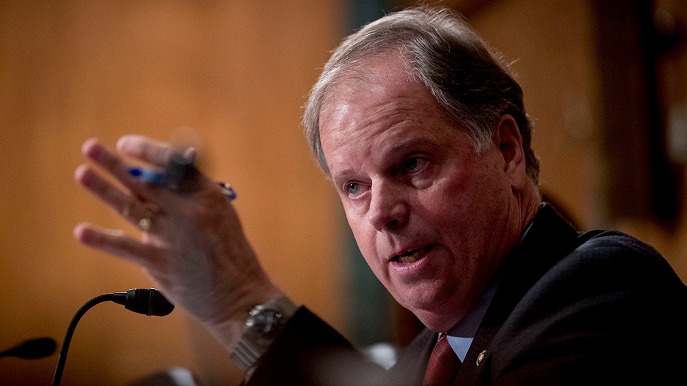 Sen. Doug Jones, D-Ala., speaks at a Senate Banking Committee hearing on
