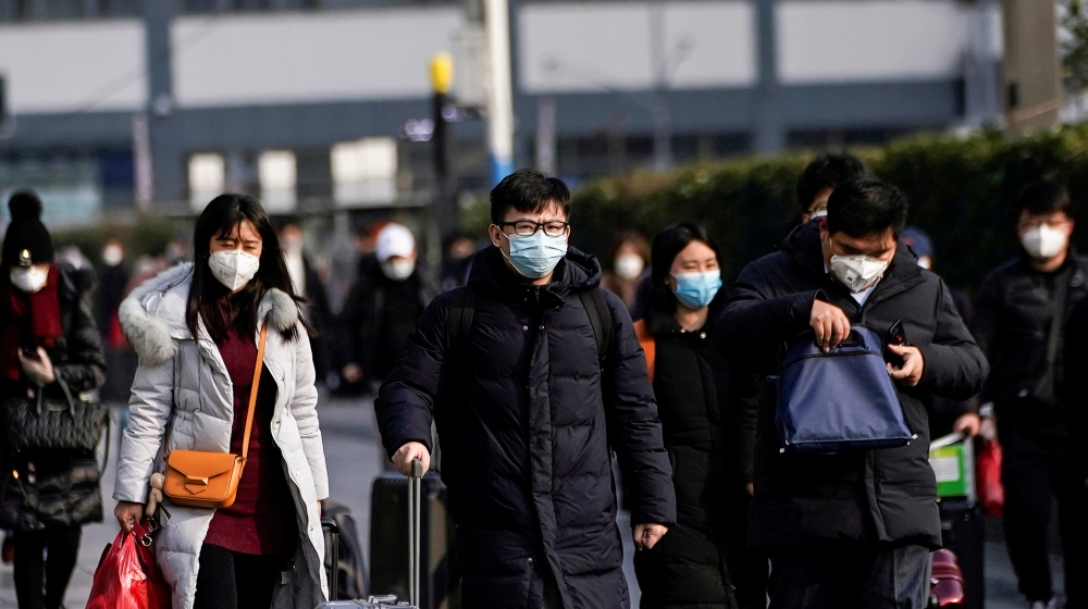 Passengers wearing masks walk at the Shanghai railway station in China, as the country is hit by an outbreak of the novel coronavirus, February 9, 2020. REUTERS/Aly Song