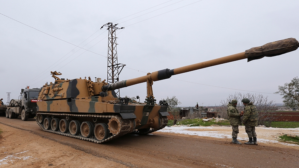 Turkish military convoy is seen near the town of Idlib, Syria, Wednesday, Feb. 12, 2020. Turkish President Recep Tayyip Erdogan said Wednesday that Turkey will attack government forces anywhere in Syr
