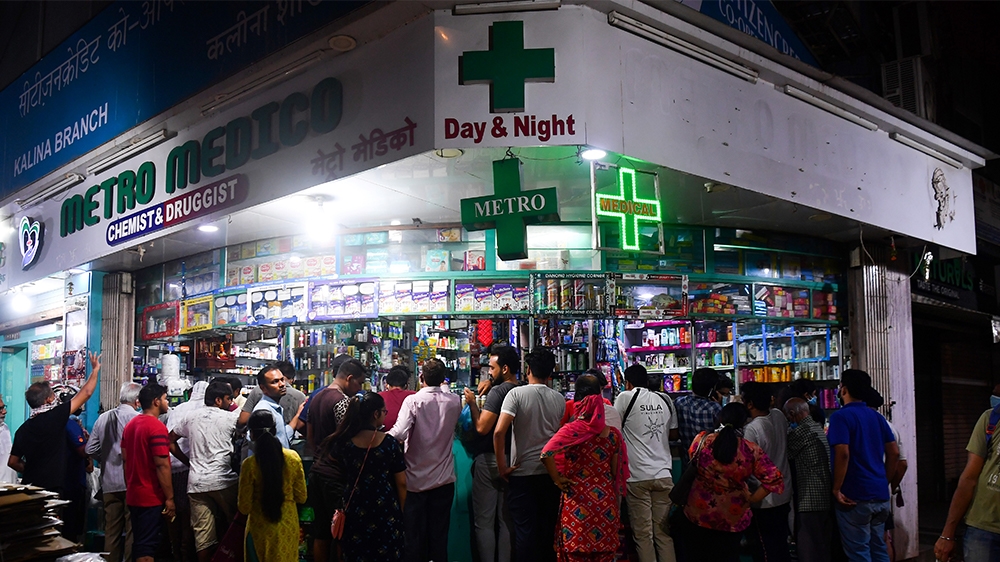 People gather at a pharmacy to buy supplies following Indian Prime Minister''s announcement of a government-imposed nationwide lockdown as a preventive measure against the COVID-19 coronavirus in Mumba