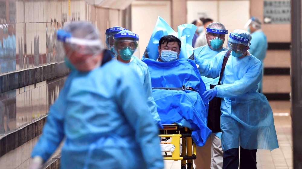 Medical staff transfer a patient of a highly suspected case of a new coronavirus at the Queen Elizabeth Hospital in Hong Kong, China January 22, 2020. Picture taken January 22, 2020. cnsphoto via REUT