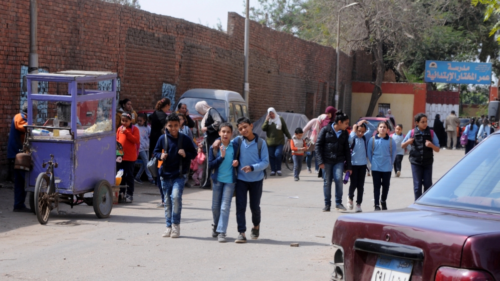 School children leave the primary school of Omar El Mokhtar in Cairo, Egypt